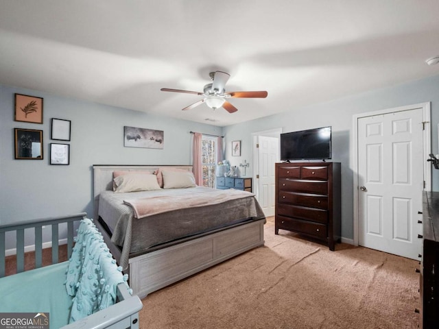 carpeted bedroom with ceiling fan