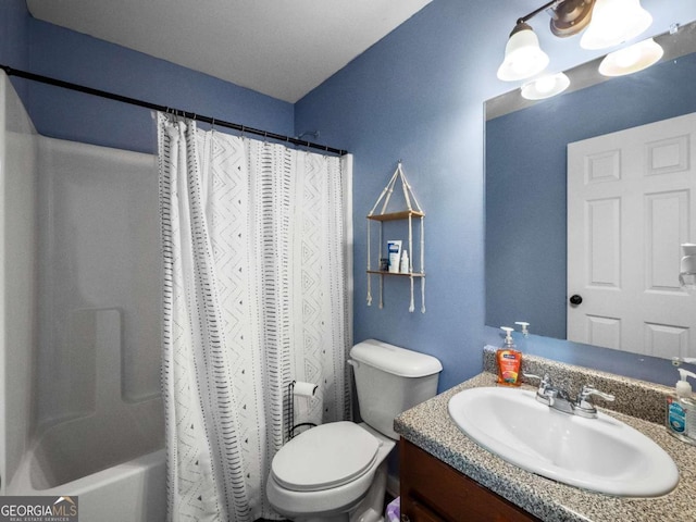 full bathroom with shower / tub combo with curtain, vanity, and toilet