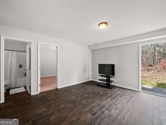 unfurnished living room featuring dark hardwood / wood-style floors and a wealth of natural light