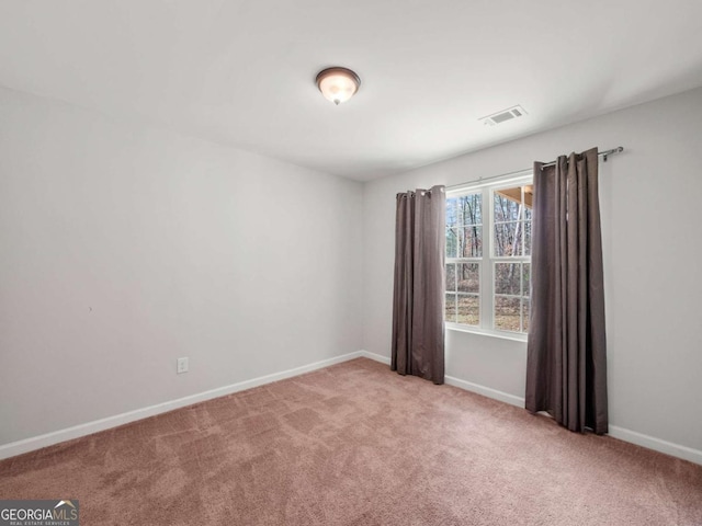 unfurnished room with light carpet