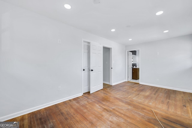 empty room with light hardwood / wood-style flooring