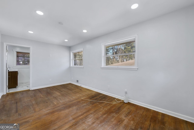 spare room featuring wood-type flooring