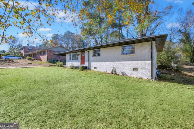 ranch-style home with a front lawn