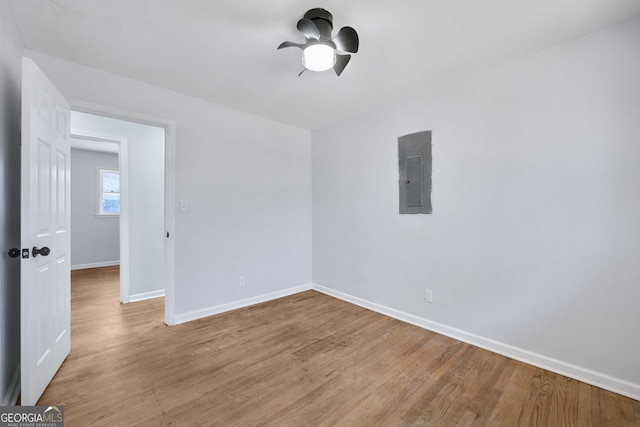 spare room featuring light hardwood / wood-style floors and electric panel