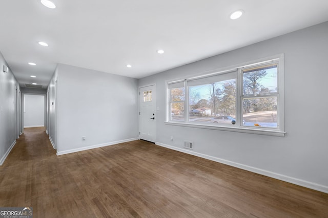 unfurnished room featuring dark hardwood / wood-style flooring