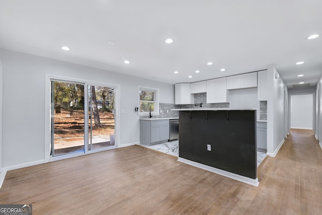 kitchen featuring white cabinets, dishwasher, gray cabinets, and light wood-type flooring