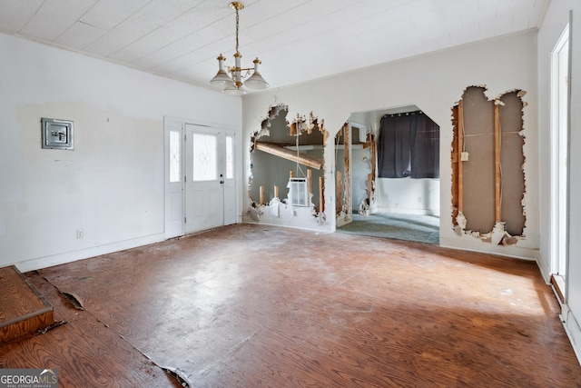 entrance foyer with hardwood / wood-style floors and an inviting chandelier