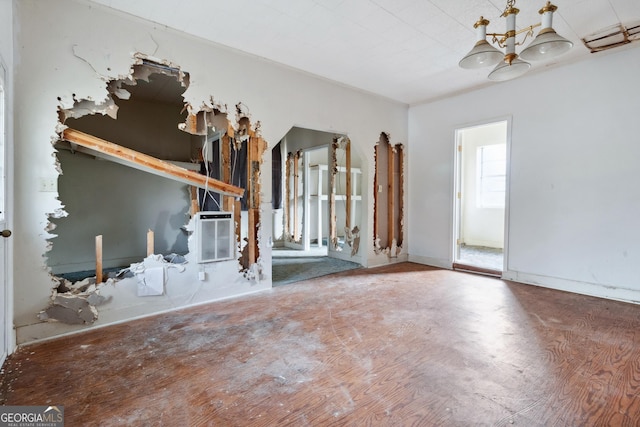 unfurnished living room featuring a chandelier and wood-type flooring