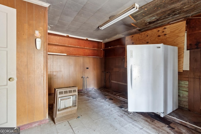 miscellaneous room featuring wooden walls and heating unit