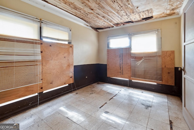 unfurnished room featuring ornamental molding and wooden ceiling