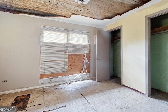 unfurnished bedroom featuring crown molding and wooden ceiling