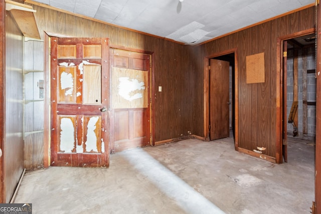 foyer entrance with concrete floors and wood walls