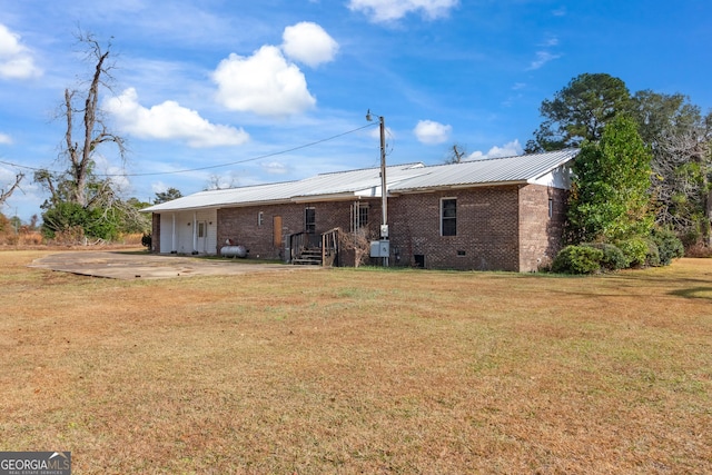 rear view of property featuring a yard