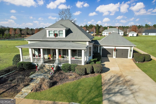 farmhouse inspired home featuring a garage, covered porch, and a front lawn