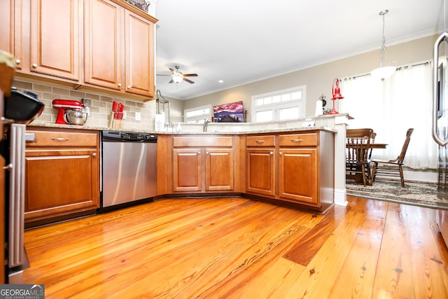 kitchen featuring stainless steel dishwasher, brown cabinetry, and crown molding