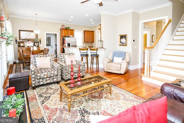 living room with light hardwood / wood-style flooring and ornamental molding