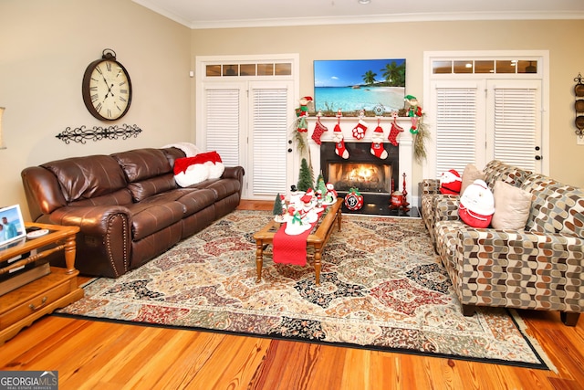 living room featuring hardwood / wood-style flooring and crown molding