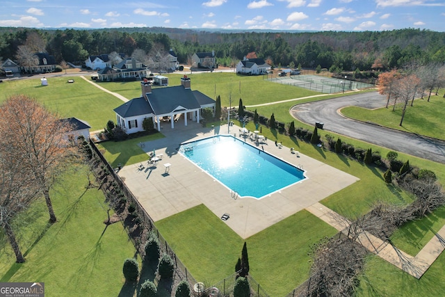 pool with a yard, fence, and a patio