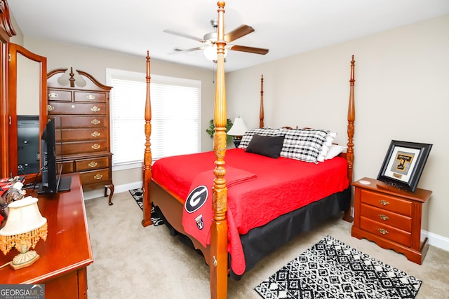 bedroom featuring baseboards, a ceiling fan, and light colored carpet