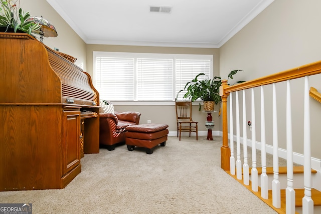 living area with visible vents, ornamental molding, baseboards, and light colored carpet