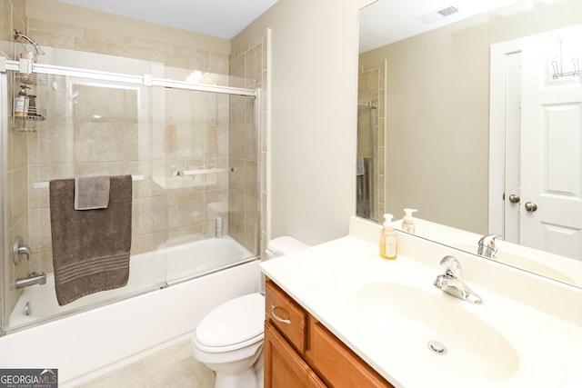 full bath with visible vents, shower / bath combination with glass door, vanity, and toilet