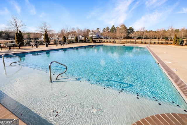 pool featuring a patio area and fence