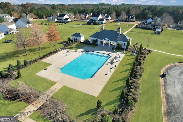 view of swimming pool featuring a residential view and fence