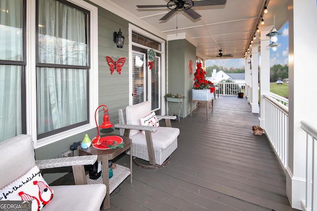 wooden deck featuring a porch and a ceiling fan