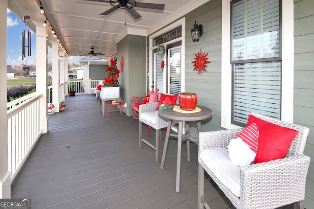 wooden deck with ceiling fan and covered porch