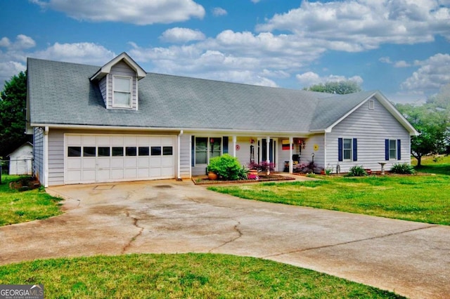 view of front of house with a garage and a front lawn