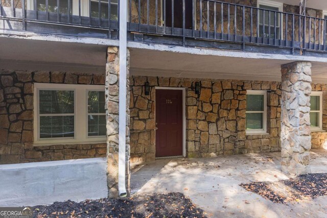 view of exterior entry featuring a balcony