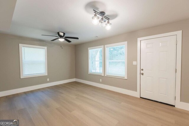 foyer with ceiling fan and light hardwood / wood-style floors