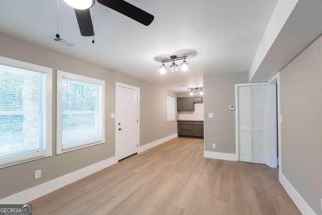 interior space featuring light wood-type flooring and ceiling fan