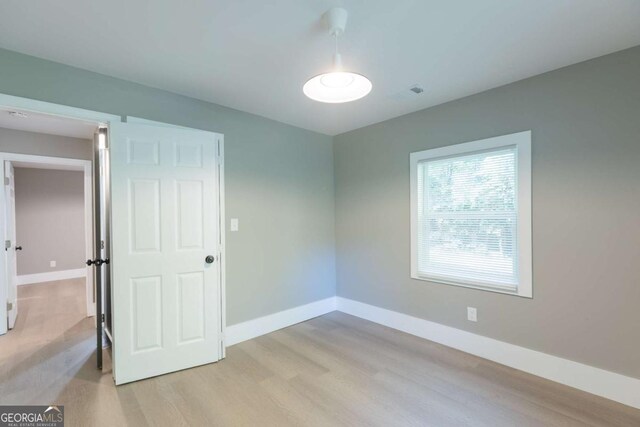 spare room with light hardwood / wood-style floors