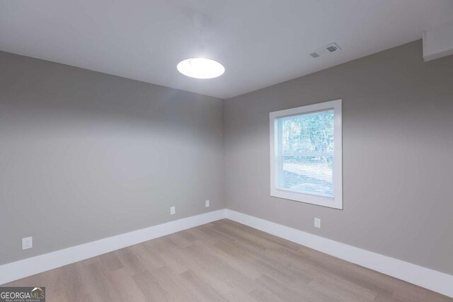 empty room with light hardwood / wood-style flooring