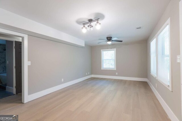 spare room featuring light hardwood / wood-style flooring and ceiling fan