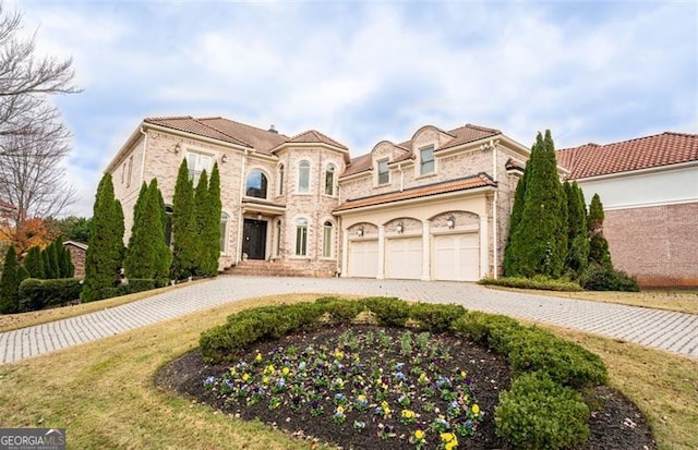 mediterranean / spanish-style house with a garage