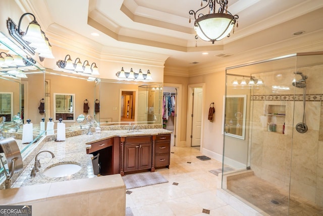 bathroom with vanity, a raised ceiling, a shower with door, and ornamental molding