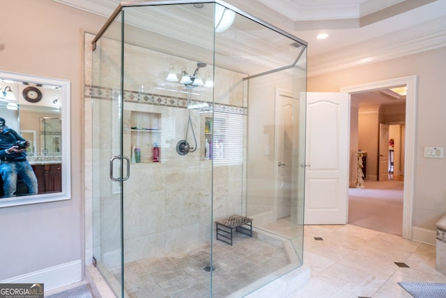 bathroom featuring tile patterned flooring, a shower with door, and crown molding