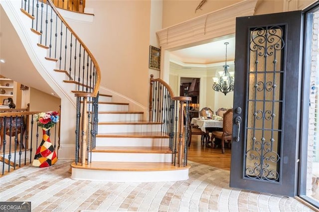 entrance foyer featuring wood-type flooring and a notable chandelier