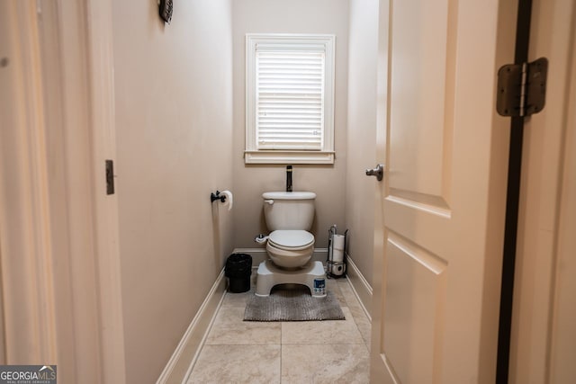 bathroom with tile patterned flooring and toilet