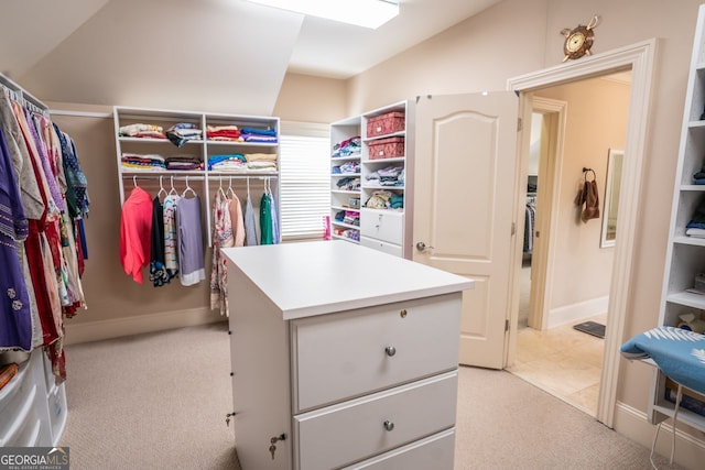 spacious closet featuring light carpet