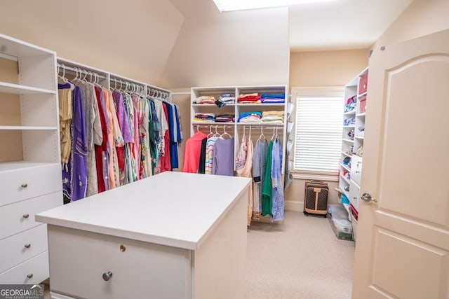 walk in closet featuring carpet and vaulted ceiling