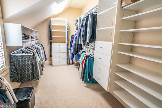 spacious closet with carpet flooring and vaulted ceiling