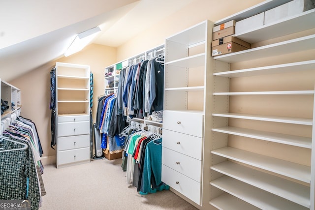 spacious closet featuring light carpet