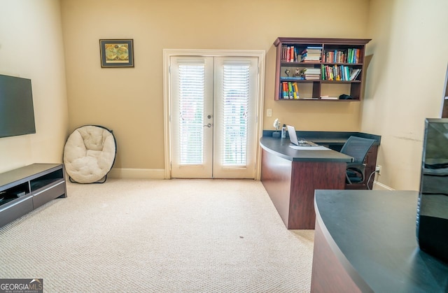 carpeted home office with french doors