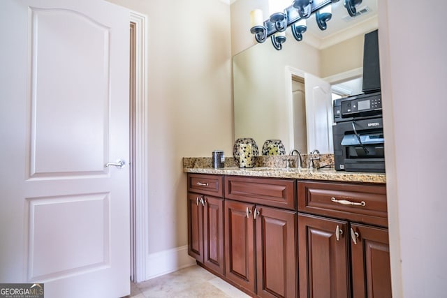 bathroom featuring tile patterned flooring and vanity