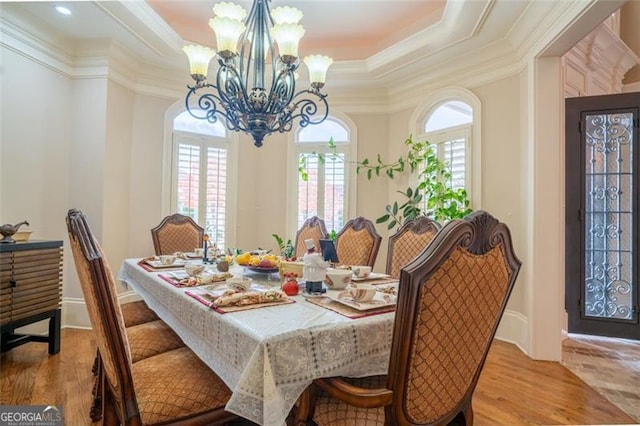 dining space featuring crown molding, a healthy amount of sunlight, and light wood-type flooring