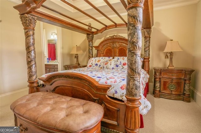 carpeted bedroom with ensuite bathroom and crown molding