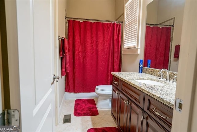 bathroom with a shower with shower curtain, vanity, toilet, and tile patterned floors